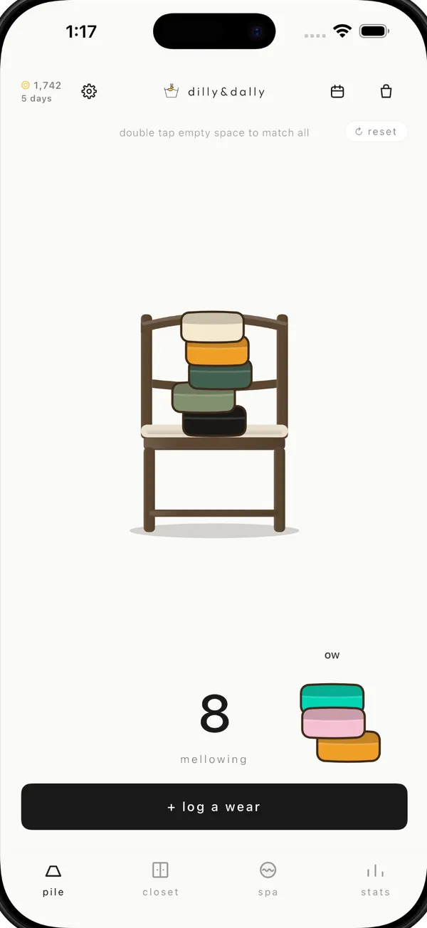 The chair pile: worn clothes folded on a chair, eight of them mellowing.